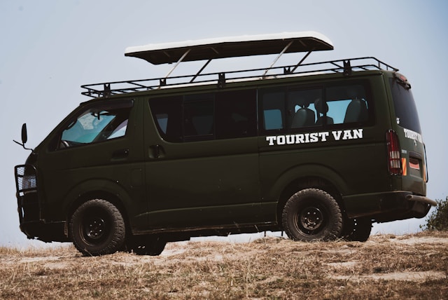A green tourist 4x4 vehicle in Queen Elizabeth National Park Uganda