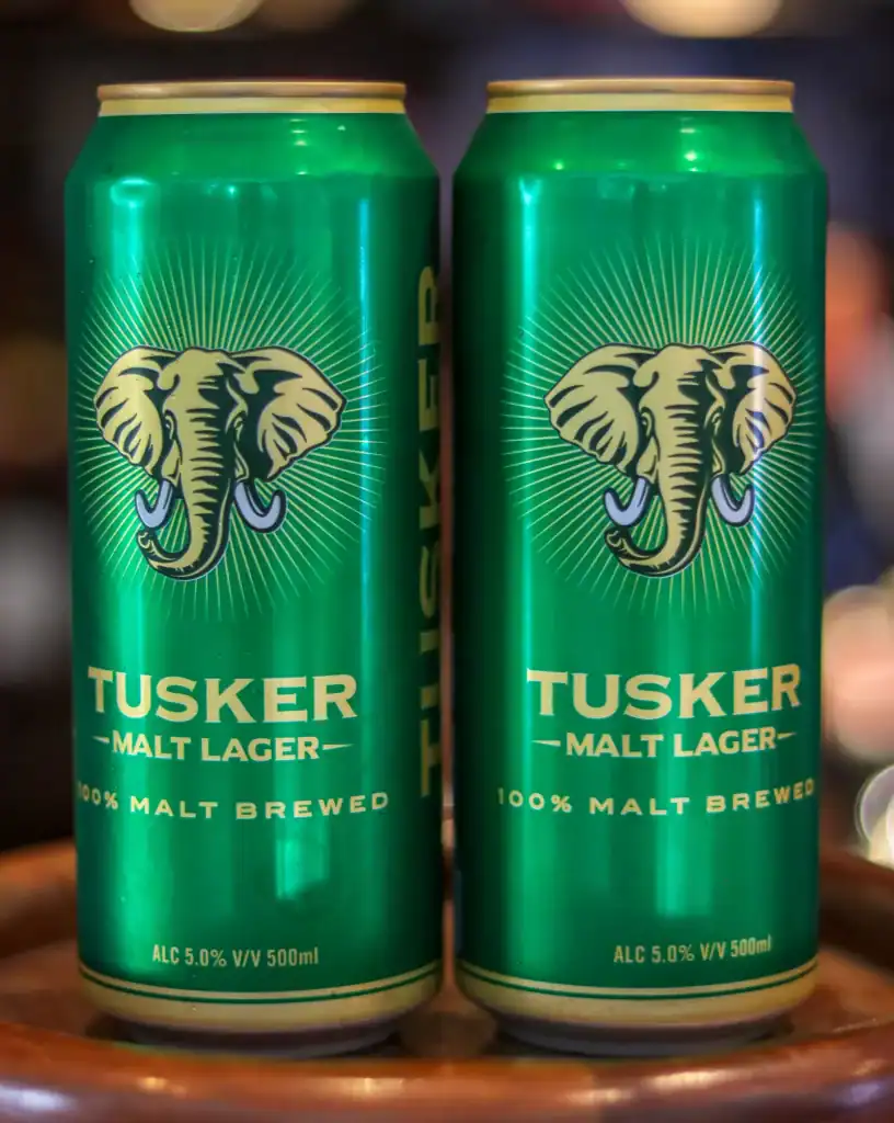 Two cans of Tusker Malt lager